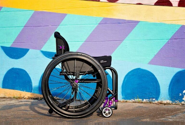 How to keep your wheelchair cushion in tip top shape - Whellchair with cushion on it in front of a colorful mural