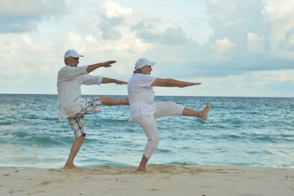 Safe Exercises For Seniors - Seniors Stretching on the Beach