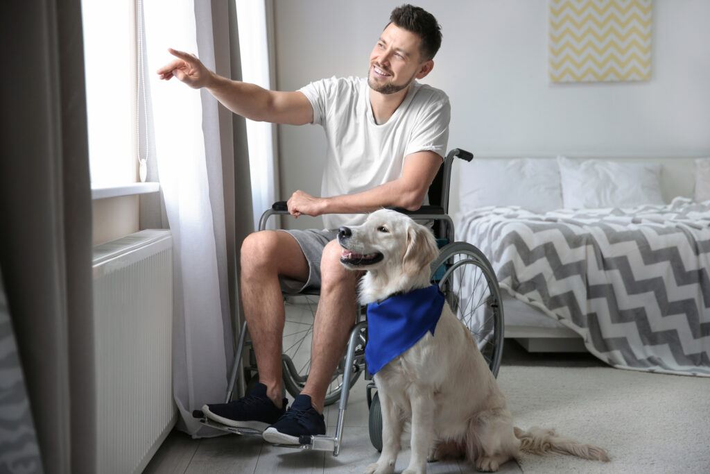 ADA Compliant Bedroom - Man in wheelchair with a dog