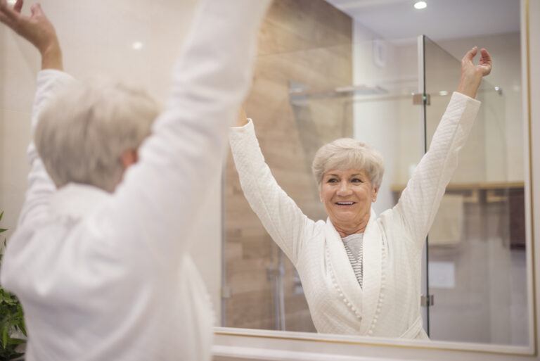 Lady in mirror looking happy after shower