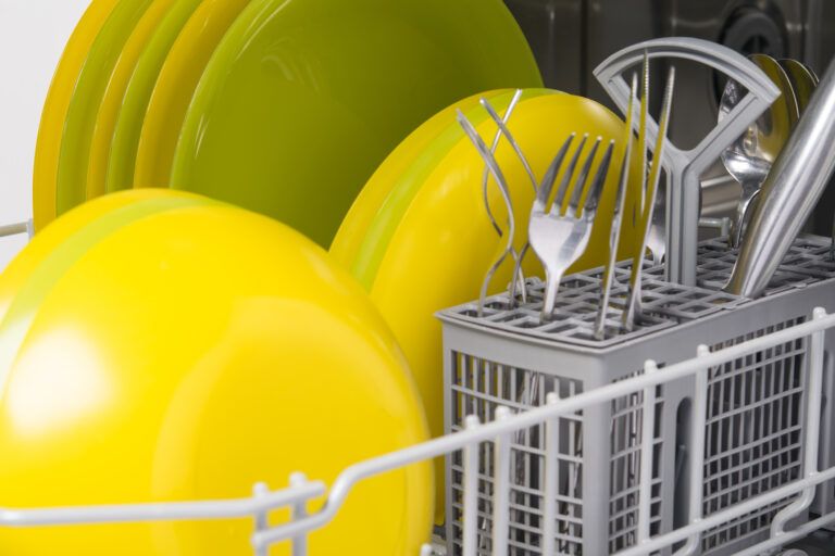 Yellow dishes in a dishwasher