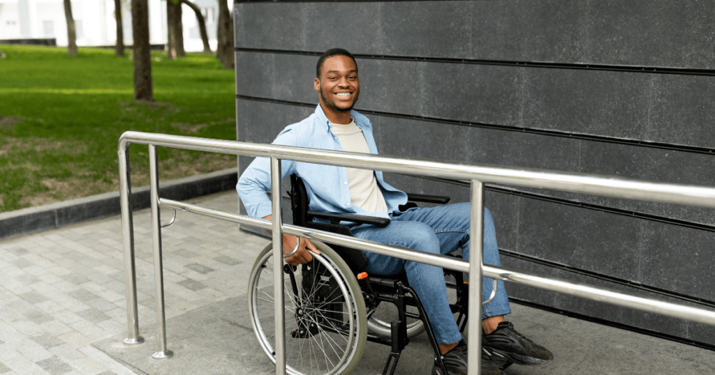 man in a wheelchair going up a ramp
