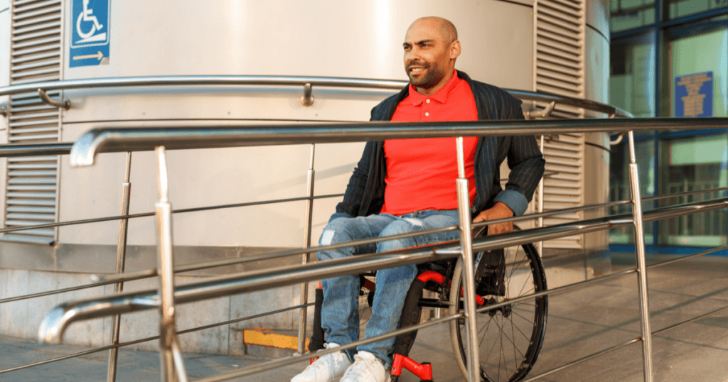 man in a wheelchair going down a ramp