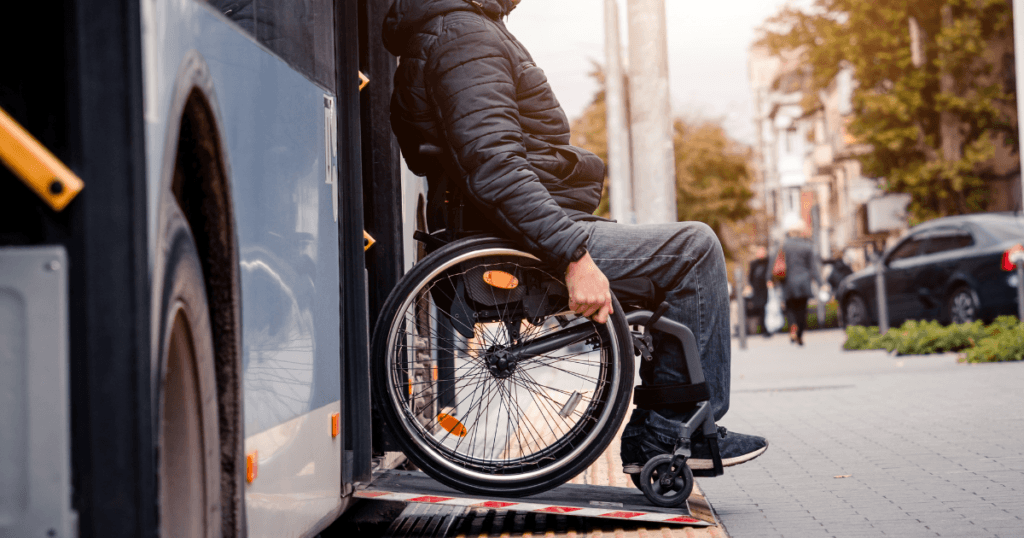 man coming off a bus in a wheelchair on a ramp
