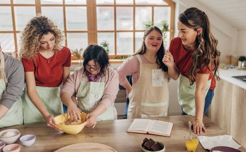 Disabled folks have fun cooking with caretaker
