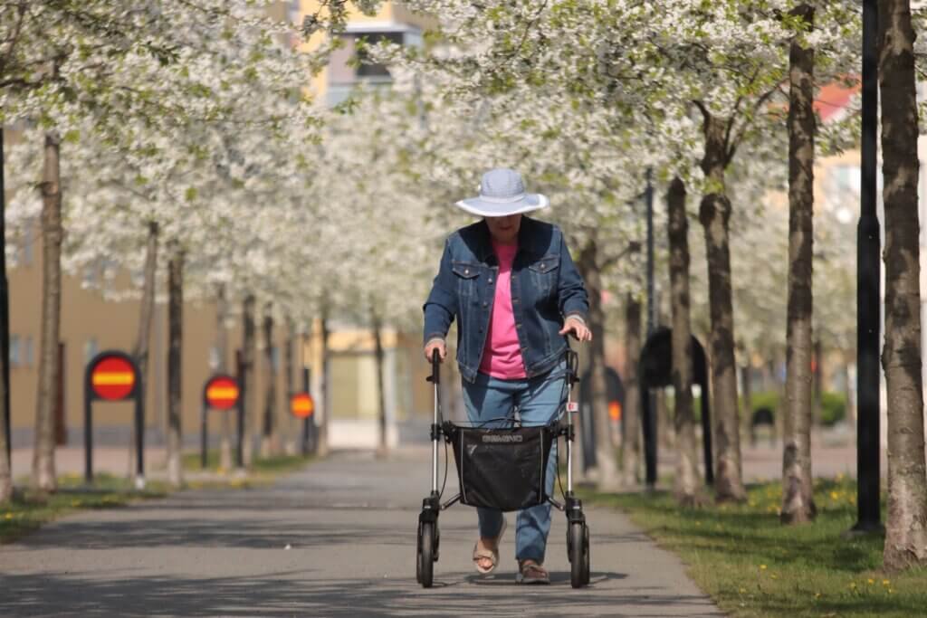 Lady taking a walk in the park with her rollator
