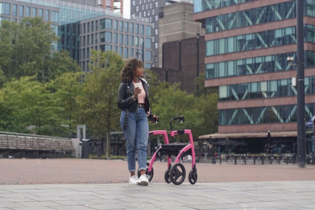 Young lady taking a break using a pink walker