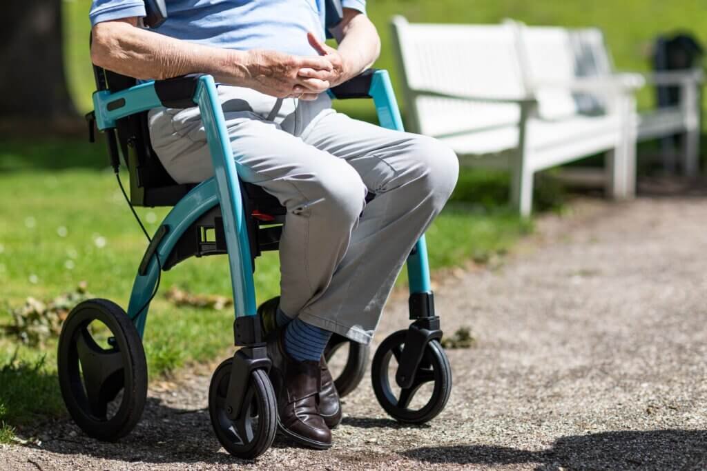 gentleman sitting in his rollator taking a break