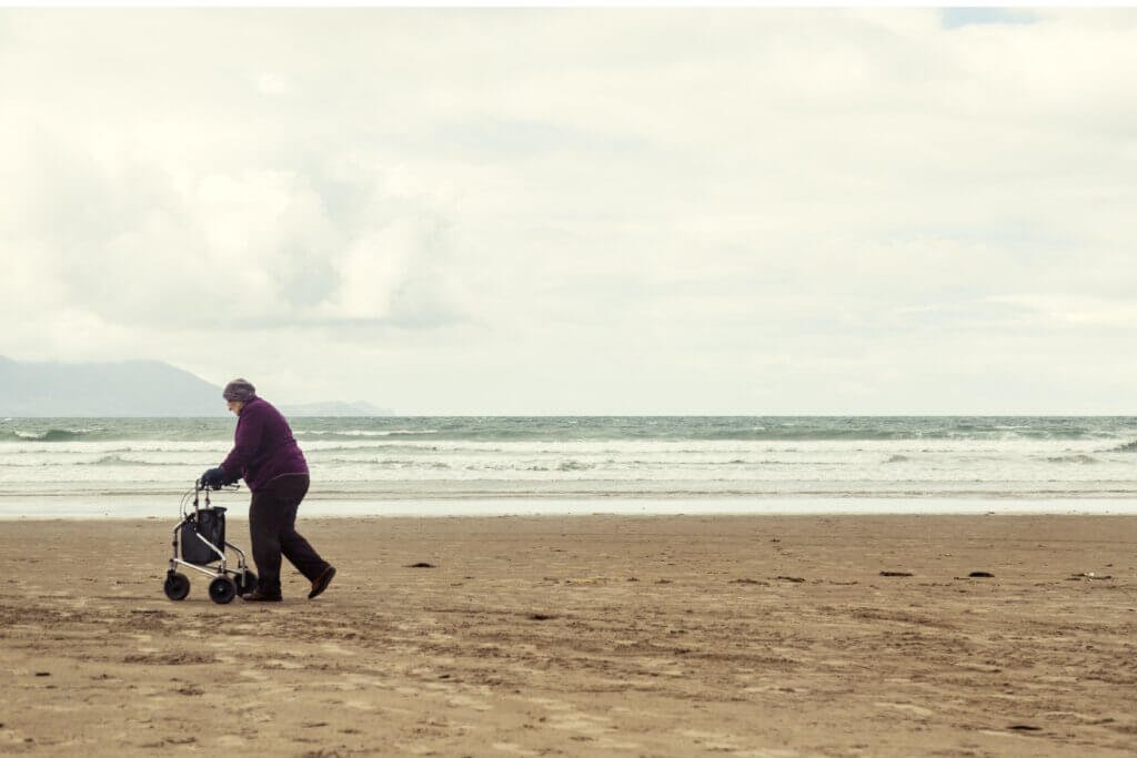 lady taking a walk on the beach with her rollator (1)