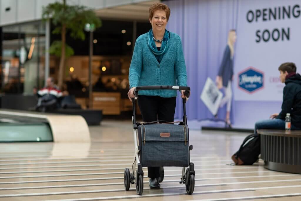 woman talking a walk in the with her rollator