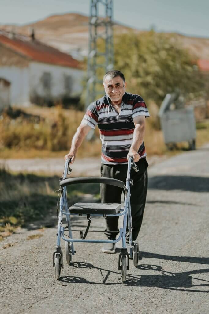 Gentleman on a road using a walker