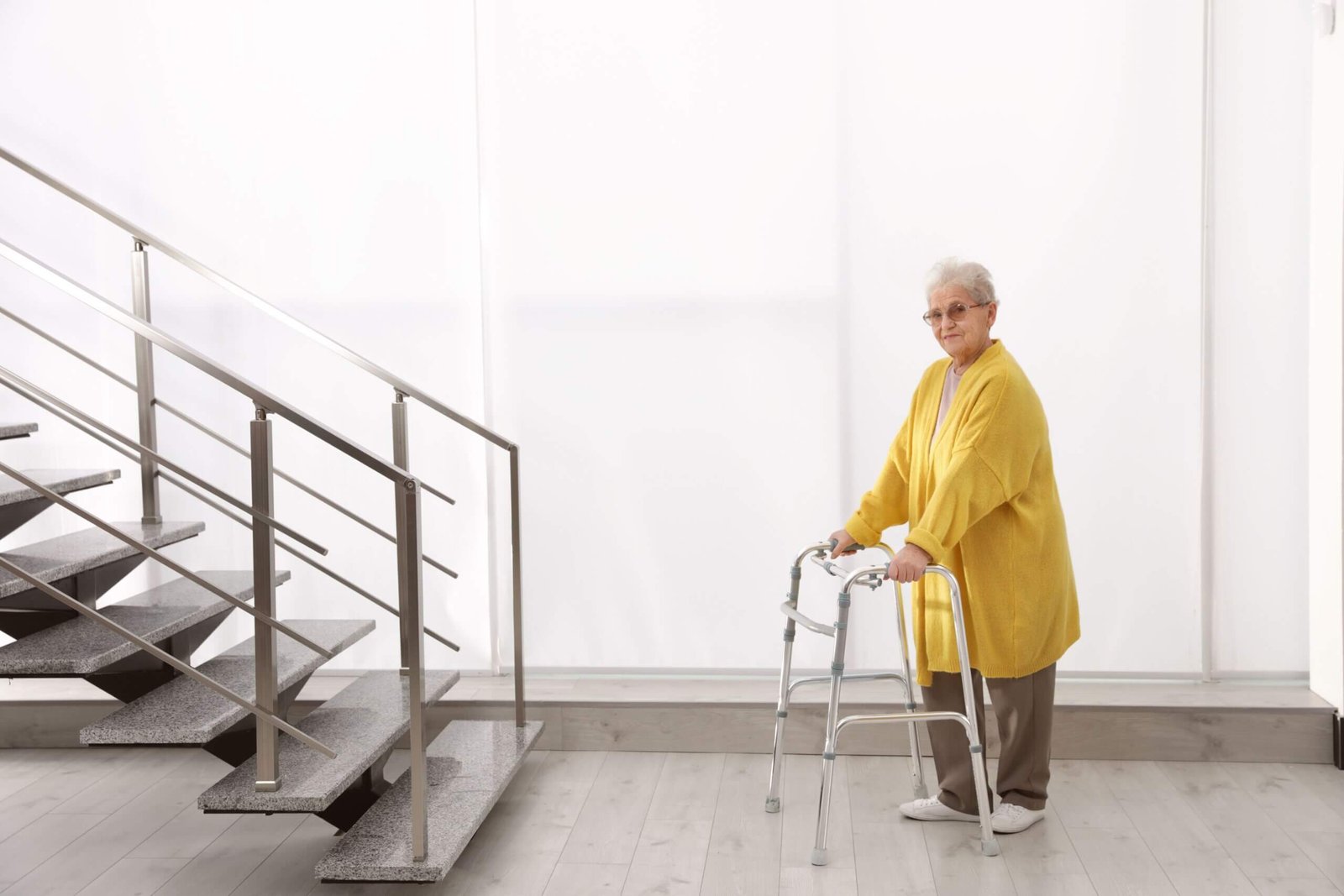 Lady On A Walker and a flight of stairs