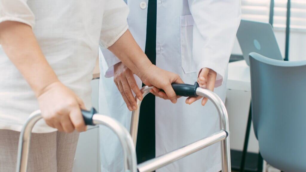 Lady-on-a-walker-making-sure-it-is-the-right-height-for-her.