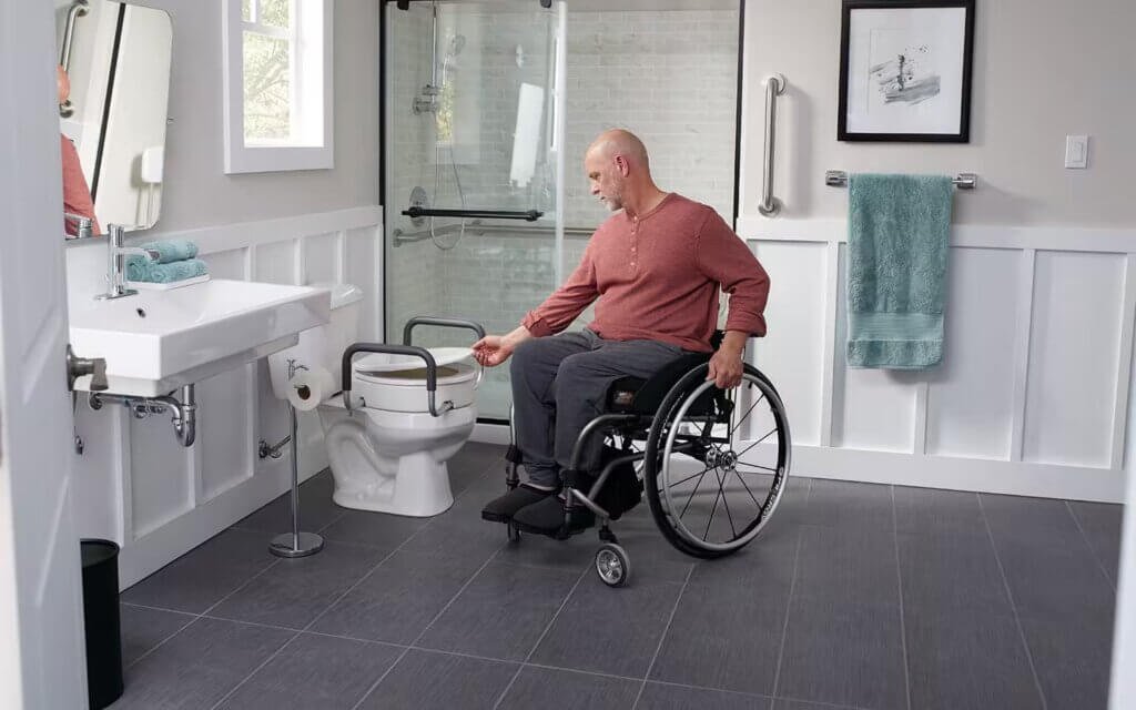 Man in a wheelchair in a Adaptive bathroom