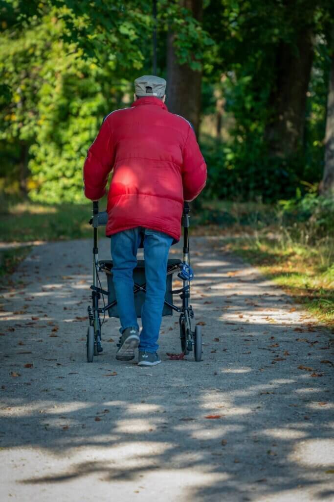 Older man using a walker outside