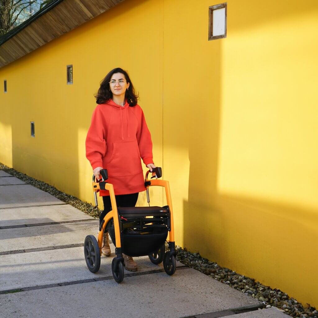 Young woman using a walker outside