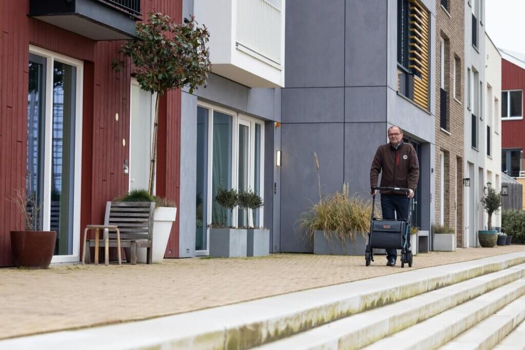 man using a walker near some stairs