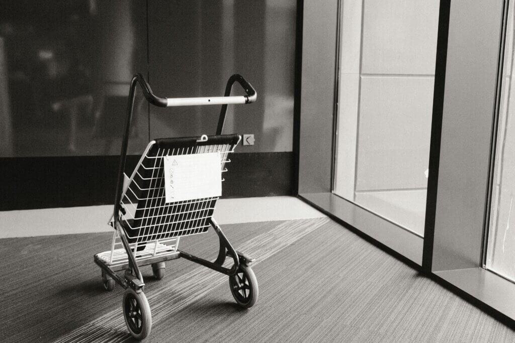walker with a seat in front of some widows