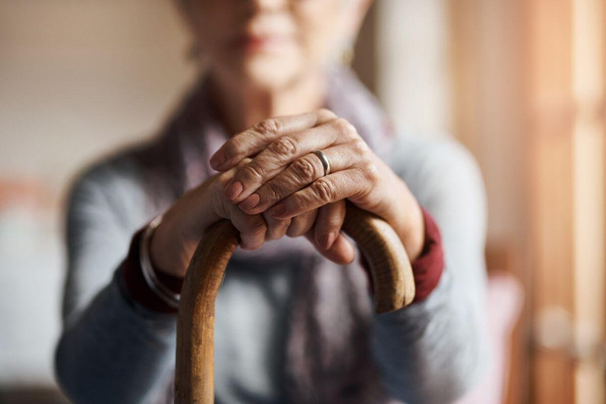 Lady holding a cane in her hand Fall prevention in the home