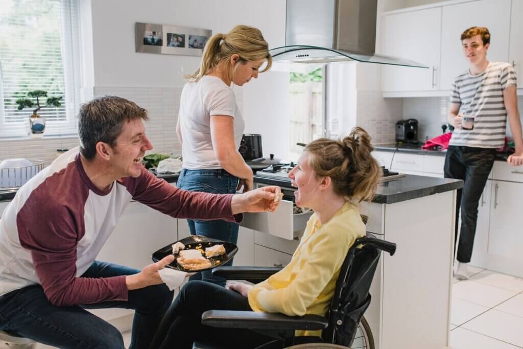 Accessible kitchen that allows a wheelchair user to participate in cooking and family activities.