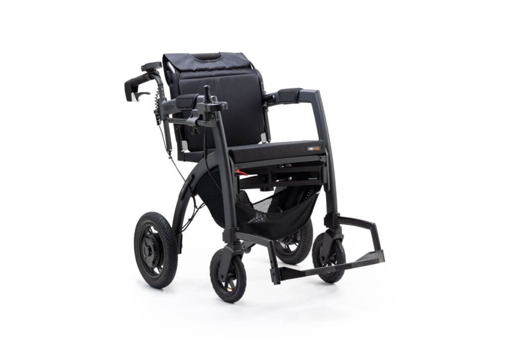 Black rollator transport chair featuring a padded seat, backrest, folding footrests, hand brakes, storage basket, and four wheels for mobility and caregiver-assisted transport.