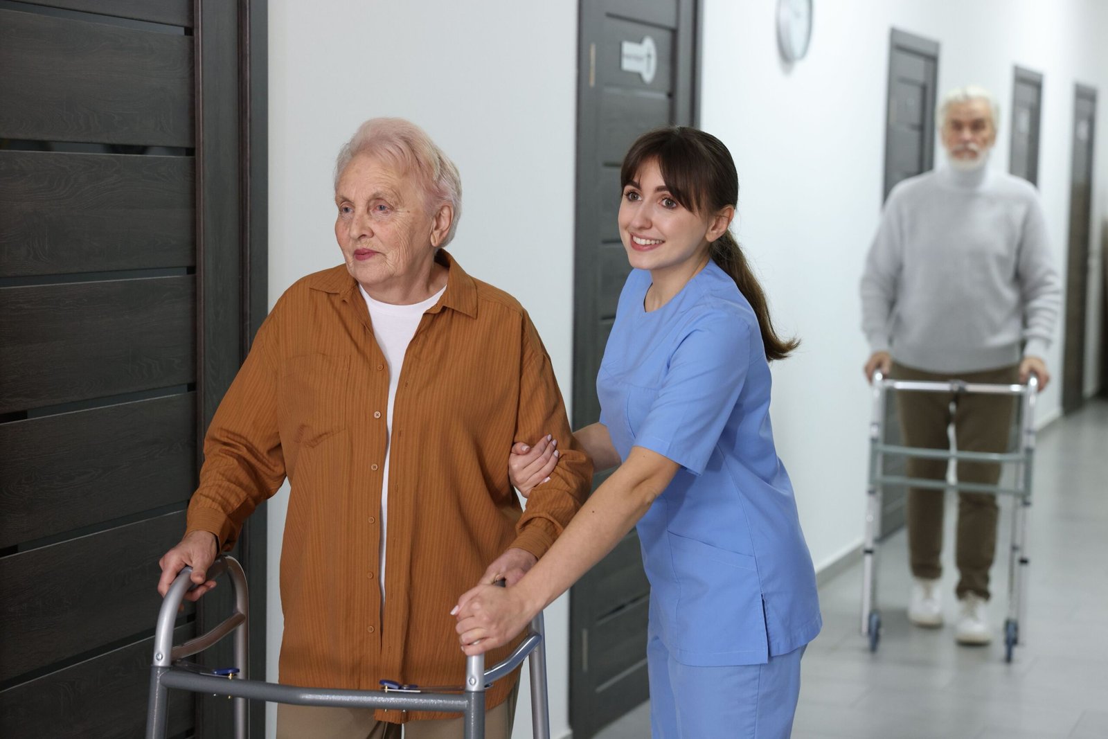 Older adult learning to use a standard walker with caregiver support during mobility rehabilitation
