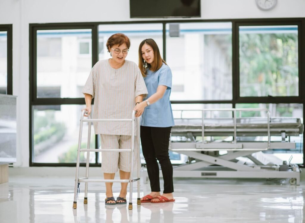 Do You Need a Prescription for a Walker? Patient using a standard walker during physical rehabilitation with caregiver support in a healthcare facility.