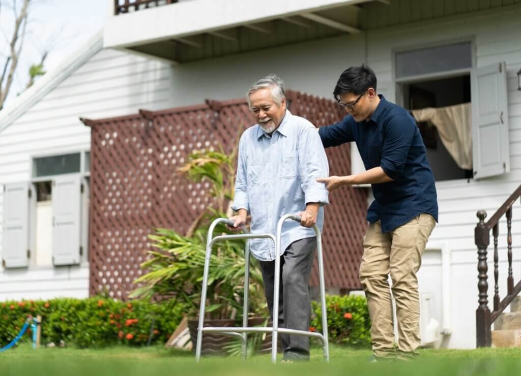 man being helped using his walker 
