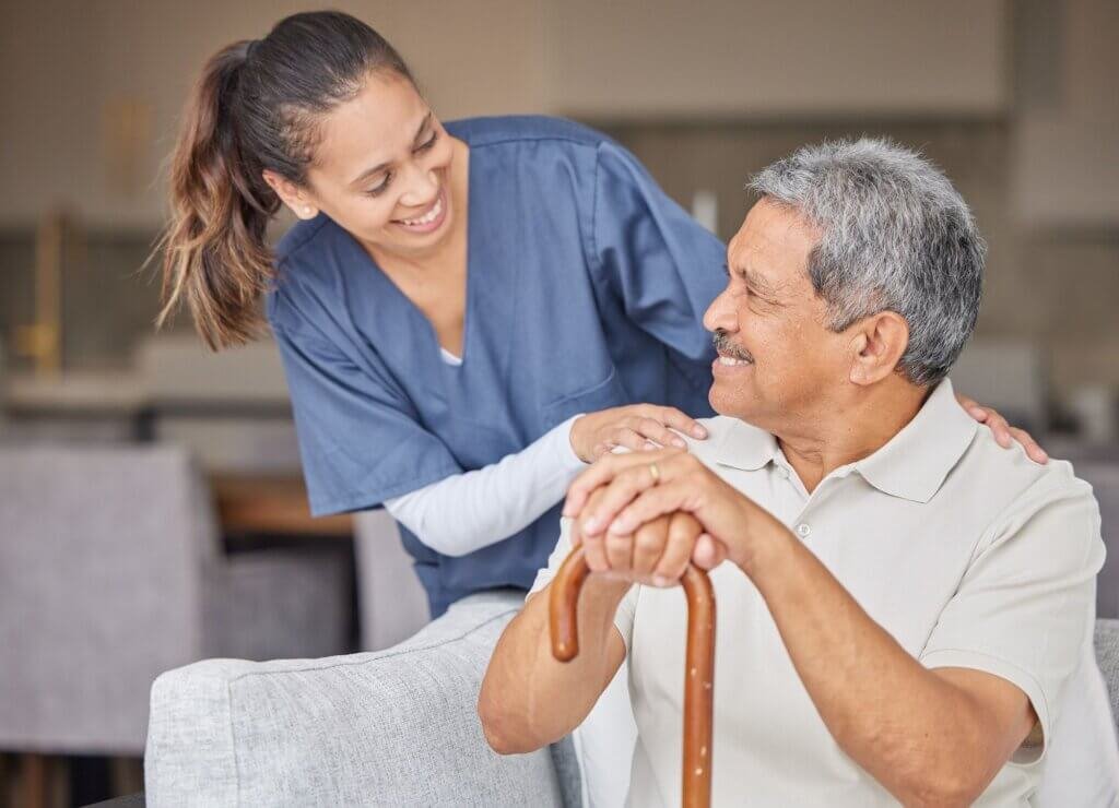 man with a cane talking to his nurse