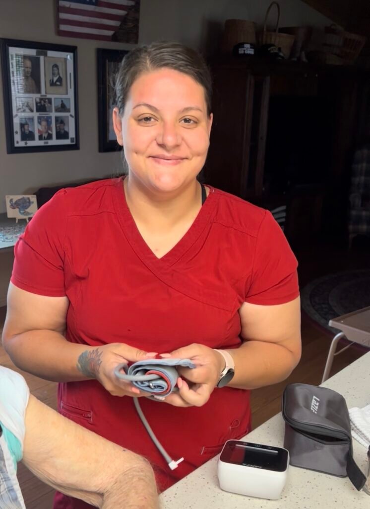 Jessica, my dad’s longtime CNA caregiver, holding a blood pressure cuff during an in-home care visit.